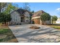 Charming brick home featuring a circular driveway and an attached two-car garage at 103 Devonshire Ln, Salisbury, NC 28146