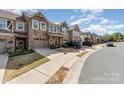 Street view of attractive townhomes with stone facade, integrated garages, and concrete driveways at 1030 Archibald Ave, Fort Mill, SC 29708