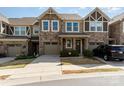 Charming townhome featuring stone accents, a one-car garage, and well-maintained landscaping at 1030 Archibald Ave, Fort Mill, SC 29708
