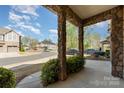 Inviting covered porch featuring stone columns, offering a pleasant neighborhood view at 1030 Archibald Ave, Fort Mill, SC 29708