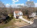Aerial view of a lovely home with a large yard and mature trees at 105 Elk Ct, Mount Holly, NC 28120