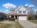 Inviting two-story home with blue shutters and a well-maintained front yard at 105 Elk Ct, Mount Holly, NC 28120