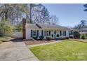 Charming one-story home with a well-manicured lawn, beautiful landscaping, and inviting light blue front door at 10849 Flat Iron Rd # 11, Charlotte, NC 28226