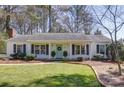 Charming one-story home with a well-manicured lawn, beautiful landscaping, and inviting light blue front door at 10849 Flat Iron Rd # 11, Charlotte, NC 28226