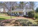 Charming one-story home with a well-manicured lawn, beautiful landscaping, and inviting light blue front door at 10849 Flat Iron Rd # 11, Charlotte, NC 28226