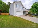 Well-maintained two-story home with a two car garage, green lawn, and inviting front entrance at 113 Devynn Ridge Ct, Mount Holly, NC 28120