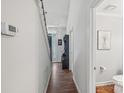 Bright hallway featuring wood floors, staircase, and entry to bathroom at 11333 Snapfinger Dr, Charlotte, NC 28277
