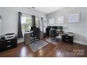 Bright home office featuring wood floors, two desks, and large windows, perfect for a productive workspace at 128 Front Porch Dr, Rock Hill, SC 29732