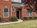 Inviting entryway with black front door framed by white trim and manicured landscaping at 130 Villa Lake Dr, Fort Mill, SC 29708