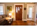 Beautiful entryway featuring a custom wooden door, hardwood floors, and stylish decor at 139 S Laurel Ave, Charlotte, NC 28207