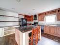 Well-appointed kitchen featuring dark countertops, stylish cabinetry, an island and modern appliances at 1459 Wehunt Store Rd, Cherryville, NC 28021