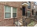 Close up exterior showcasing brick facade, black door and stairs to entry at 15041 New Amsterdam Ln, Charlotte, NC 28204