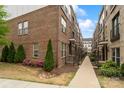 Charming townhome exterior featuring landscaped walkway and brick facade at 15041 New Amsterdam Ln, Charlotte, NC 28204