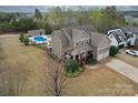 Sprawling property featuring a two-story home, an in-ground pool with fencing, and a pool house at 15211 Windward Ln, Lancaster, SC 29720