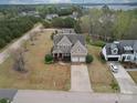 Expansive aerial view of a two-story home with a long driveway surrounded by trees and lawn at 15211 Windward Ln, Lancaster, SC 29720
