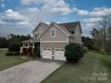Beautiful two-story home with a concrete driveway leading to an attached two-car garage at 15211 Windward Ln, Lancaster, SC 29720