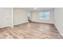Spacious living room with hardwood floors and ample natural light from a window and glass door at 1526 Cottage Creek Dr, Bessemer City, NC 28016