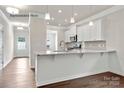 Modern kitchen featuring granite countertops, white cabinets, and stainless steel appliances at 1650 Troon Dr, Salisbury, NC 28144