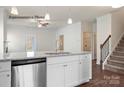 Bright kitchen island features granite countertops, stainless steel appliances, and pendant lighting at 1650 Troon Dr, Salisbury, NC 28144