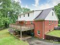 A two-story home featuring a spacious wooden deck overlooking a green lawn and backyard at 167 Cedar Ln, Troutman, NC 28166