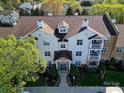 Aerial view showcasing condos with well-maintained landscaping and a blue entrance door at 17143 Red Feather Dr, Charlotte, NC 28277