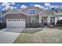 Charming two-story home with stone accents, a two-car garage, and a well-maintained front yard at 1718 Still River Way, Fort Mill, SC 29708