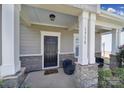Inviting front porch with stone columns and seating, creating a warm and welcoming entrance at 1718 Still River Way, Fort Mill, SC 29708