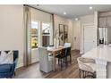 Elegant dining area adjacent to the kitchen with natural light and modern decor at 1726 Braemar Village Dr, Monroe, NC 28110