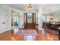 Inviting foyer with gleaming hardwood floors, elegant rug, and views into the dining and living areas at 1849 Oakmont Dr, Denver, NC 28037