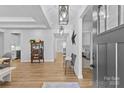 Bright foyer with hardwood floors, decorative lighting, and open view into other rooms at 2017 Autumn Dr, Monroe, NC 28110