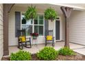 Inviting front porch featuring rocking chairs and hanging ferns, creating a cozy entrance at 2017 Autumn Dr, Monroe, NC 28110