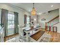 Bright dining room with wood floors, an elegant chandelier, and a farmhouse-style table and seating at 2222 Smoltz Dr, Rock Hill, SC 29730