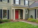 Close-up of a welcoming front entrance with a red door, showcasing the home's address and charming details at 2812 Edgebrook Cir, Matthews, NC 28105