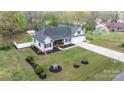 Aerial view of a well-maintained home with lush landscaping, a spacious yard, and mature trees at 2987 Irish St, Newton, NC 28658