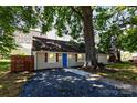 Inviting one-story house with a cozy front yard, complemented by a striking blue door at 307 S Ransom St, Gastonia, NC 28052