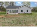 Charming home features a sunroom and spacious yard, ideal for outdoor enjoyment and expansion at 413 E Henderson Es St, East Spencer, NC 28144