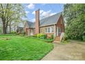 Attractive brick home with lush landscaping and a well-maintained lawn, showcasing classic charm at 431 Sullivan Rd, Statesville, NC 28677
