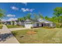 Charming single-story home featuring stone accents, a well-kept lawn, and a two car garage at 4503 Hunton Dale Nw Rd, Concord, NC 28027