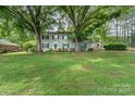 Traditional home with lush greenery and mature trees shading the front yard at 511 Plymouth Ave, Salisbury, NC 28144