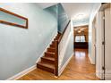 Hallway with wood floors that leads to the staircase and living room at 5664 Norwood Ridge Dr, Rock Hill, SC 29732