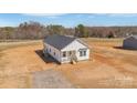 Inviting white home featuring a classic design with a covered porch and ample space for outdoor activities at 603 Mt. Wesley Church Rd, Hiddenite, NC 28636