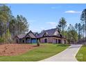 Stunning home with manicured lawn, stone accents, and long driveway at 6422 Chimney Bluff Rd, Lancaster, SC 29720
