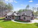 Beautiful single-story home with stone accents, manicured lawn, and mature trees at 6422 Chimney Bluff Rd, Lancaster, SC 29720
