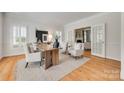 Bright living room with wood floors, French doors, and sophisticated neutral decor at 6804 Riesman Ln, Charlotte, NC 28210