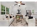 Inviting living area with modern decor, ceiling fan, lots of natural light and access to the kitchen at 699 Jackson Sw Ter, Concord, NC 28027