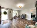 Inviting living room with dark wood floors, large windows, and lots of natural light at 7514 Secrest Shortcut Rd, Indian Trail, NC 28079