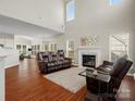 Spacious living room featuring a fireplace, high ceilings, and plenty of natural light at 10107 Atkins Ridge Dr, Charlotte, NC 28213