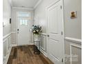 Bright foyer with hardwood floors, white trim, and a glass-paneled front door at 1066 Chicory Trce, Lake Wylie, SC 29710