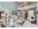 Open-concept living room with a loft view, neutral tones, hardwood floors, and comfortable seating arrangement at 119 Taylor Ct, Mooresville, NC 28117