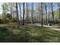 Exterior of home with driveway and mature trees at 121 Silver Fox Ct, Mount Holly, NC 28120